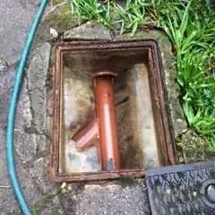 Bordon, Open drain inspection chamber showing orange drainage pipe