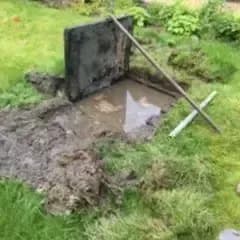 Drain Repairs, Excavated drain chamber lid lifted during a residential drain repair